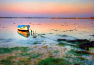 Small Boat at Shore with Tilt Shift Effect Wallpaper