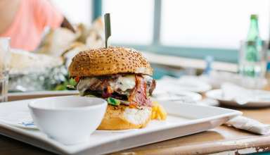 Juicy Burger in a Vibrant Interior Wallpaper