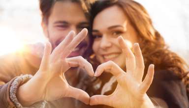 Close-up of couple making heart shape with hands Wallpaper