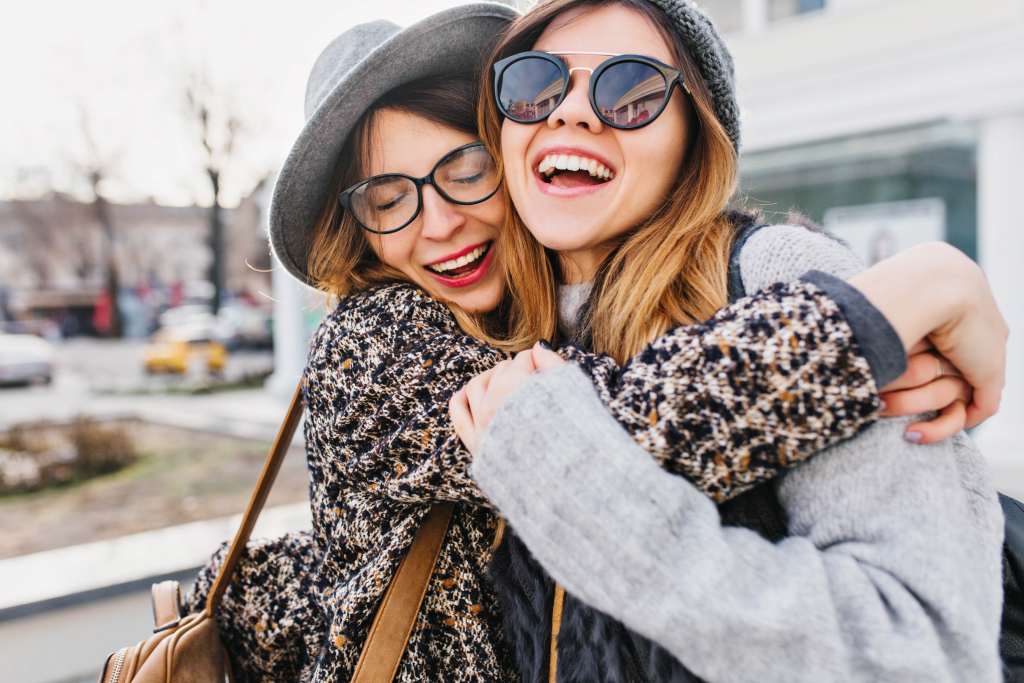 Happy brightful positive moments of two stylish girls Wallpaper