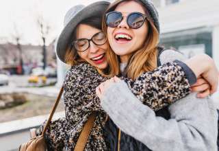 Happy brightful positive moments of two stylish girls Wallpaper