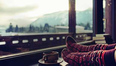 Feet in woollen socks by the Alps mountains view