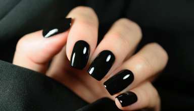 Manicure on female hands with black nail polish