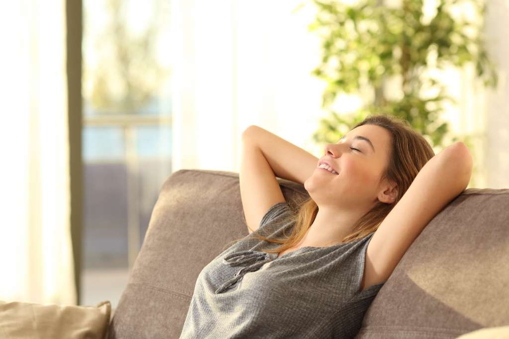 Portrait of a girl relaxing on a sofa after work at home