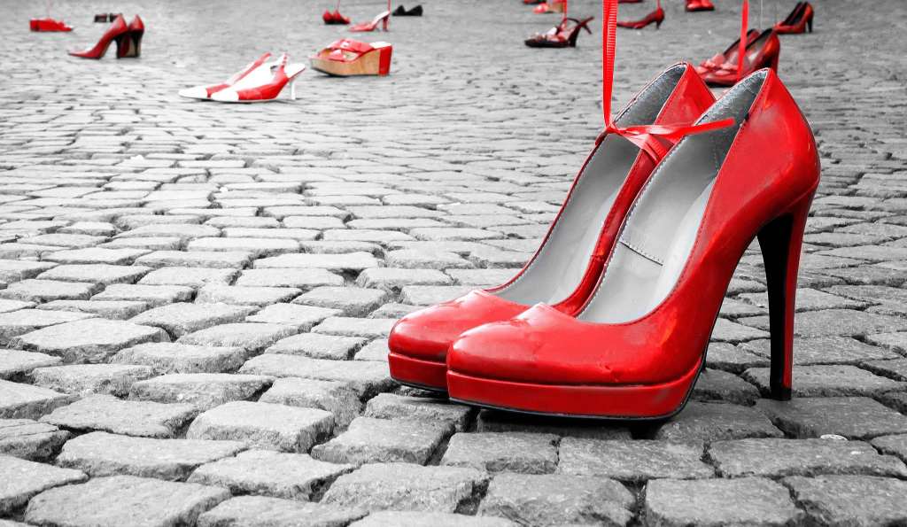 Red shoes to stop violence against women on a city square