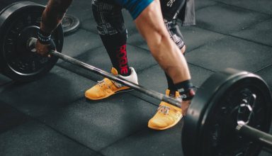 Person About to Start Lifting The Barbell Inside The gym