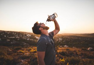 Man drinking water from water bottle Wallpaper