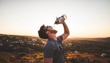 Man drinking water from water bottle Wallpaper