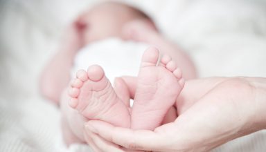 Close-up of Hands Holding Baby Feet Wallpaper