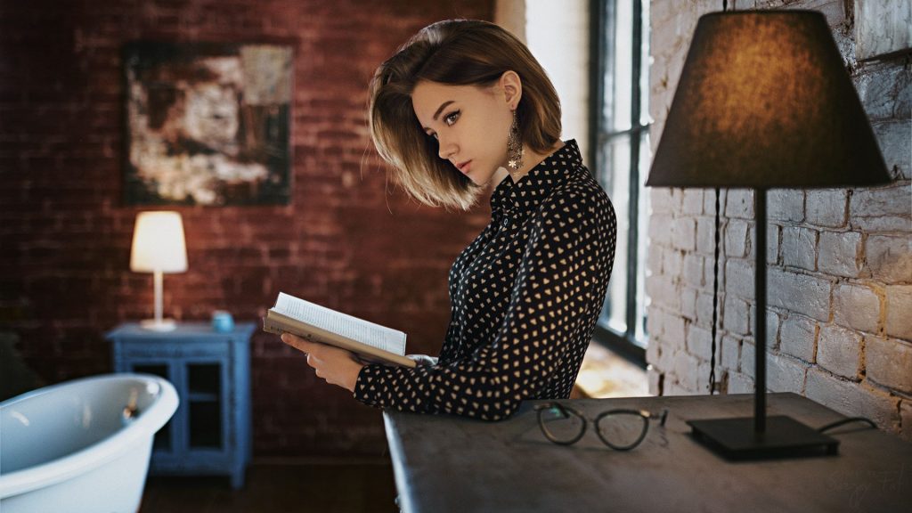 Gorgeous Girl With Book Looking Away Wallpaper