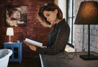 Gorgeous Girl With Book Looking Away Wallpaper