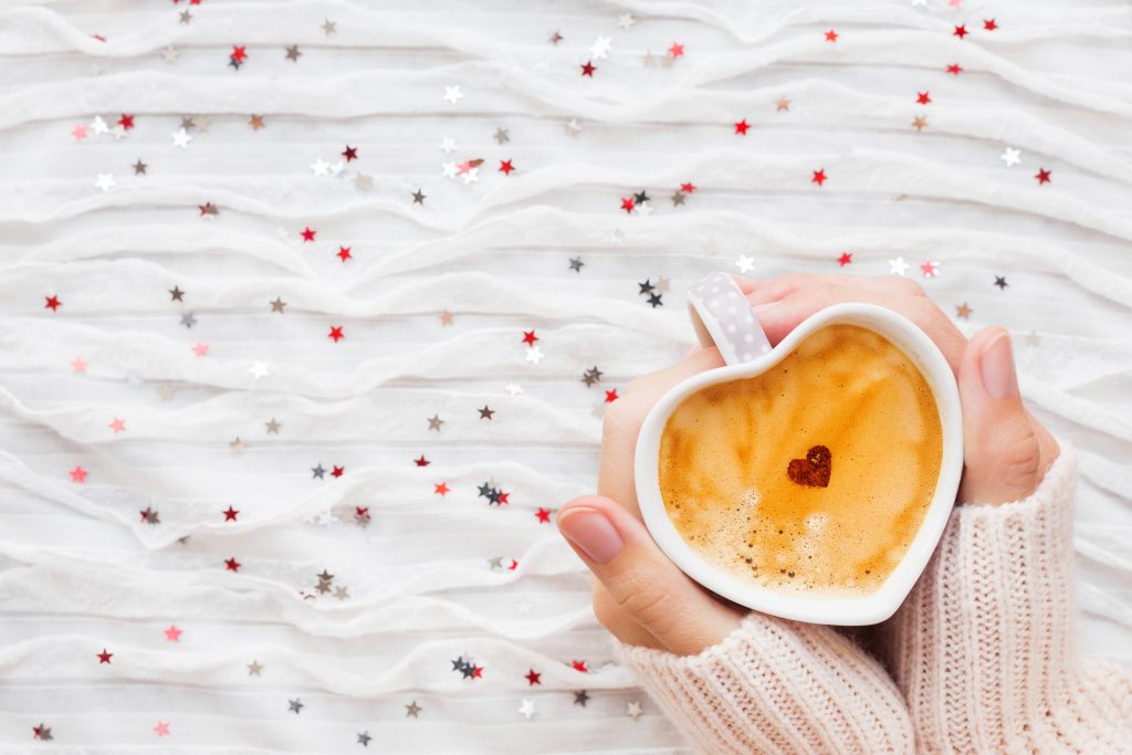 Heart Shaped Coffee Cup in Hands Wallpaper