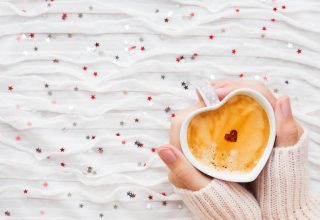 Heart Shaped Coffee Cup in Hands Wallpaper