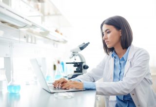 Woman Working in lab Wallpaper
