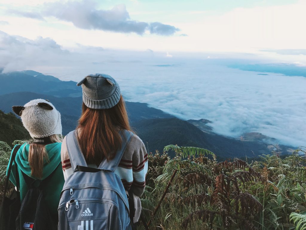 Two Woman White and Gray Crater Hat Wallpaper