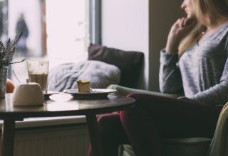 Photography of Woman Near Round Table During Daytime Wallpaper