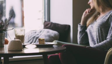 Photography of Woman Near Round Table During Daytime Wallpaper