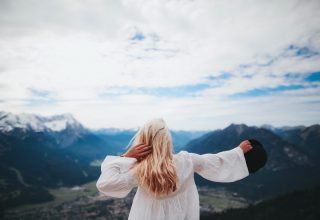 White Dressed Girl Across Black Mountains Wallpaper