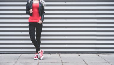 Young Woman Standing in Front of Metallic Wall