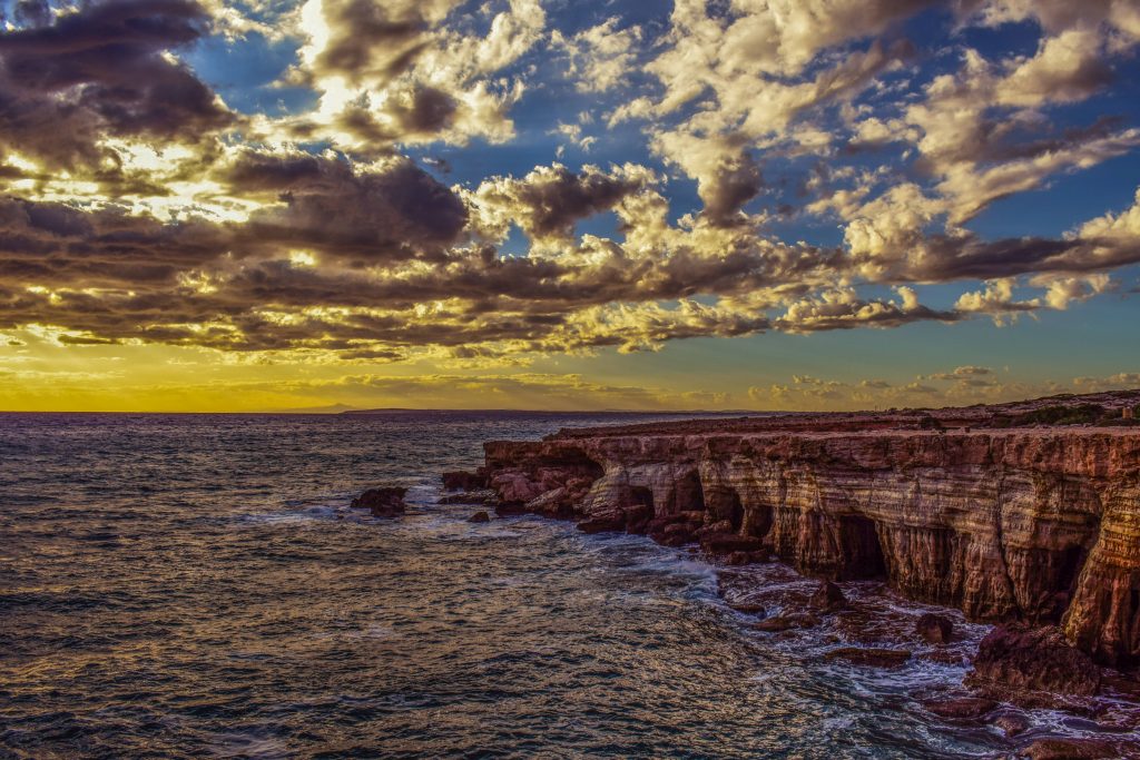 Cliff Sea Shore Stones Sky Wallpaper