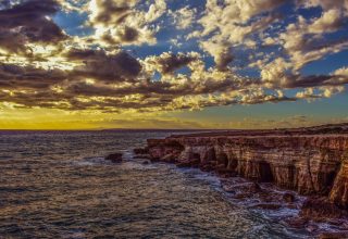 Cliff Sea Shore Stones Sky Wallpaper