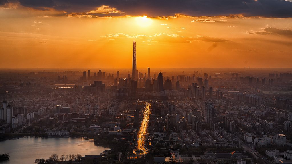 Tall Buildings Tower Sun in Clouds Lake Cityscape Wallpaper