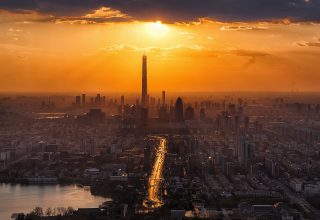 Tall Buildings Tower Sun in Clouds Lake Cityscape Wallpaper