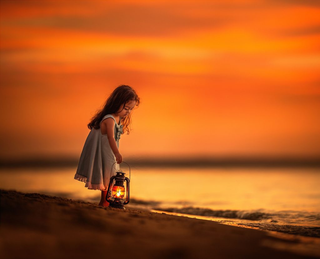 Little Girl on Beach Near Shutdown With Her Lantern Wallpaper